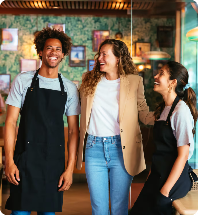 Photo image showing two happy restaurant employees and a happy guest
